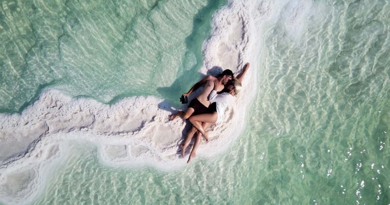 couple-tourists-are-resting-shores-dead-sea-loving-couple-lies-embrace