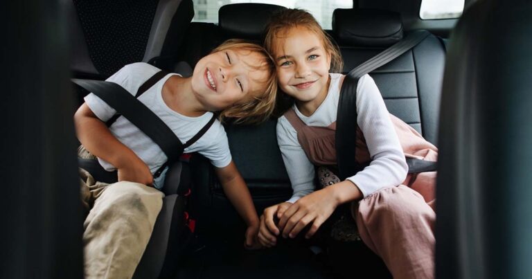 happy-siblings-sitting-back-seat-car-posing-photo-touching-with-heads-looking-camera road trip